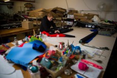 Shar Thomson glues the seams of a wetsuit at the Seventhwave Factory in Christchurch, New Zealand. 