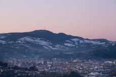 Snow lies in the shadows of Mt Cargill above the city of Dunedin, New Zealand. 