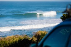 Surfers revel in a clean winter swell at St Kilda beach, Dunedin, New Zealand. 