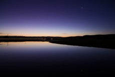 Jupiter and Venus hang in the western sky above a rural pond near Milton, Southland, New Zealand. 