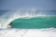 A surfer gets wave of the day at St Kilda, Dunedin, New Zealand. 