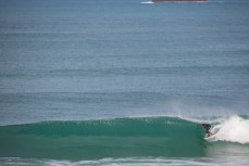 A surfer rides a barrel at St Kilda Beach, Dunedin, New Zealand. 