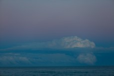 Cloud formations mimic an erupting volcano on the horizon at St Clair Beach, Dunedin, New Zealand. 