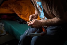 Glen Aspin sharpens the tip of his ice axe during an ice climbing session in a series of hidden valleys near Hanmer, Marlborough, New Zealand. 