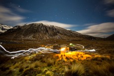 Ice climbers wander around the hut at night near Hanmer, Marlborough, New Zealand. 
