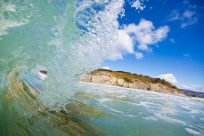 A small, fun waves breaks on a random bank on the North Coast, Dunedin, New Zealand. 