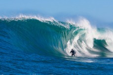 Sam Hawke stalls for a wave during a tow session at a remote reefbreak near Dunedin, New Zealand. 