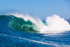 Sam Hawke rides high in the tube during a tow session at a remote reefbreak near Dunedin, New Zealand. 