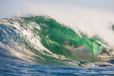 A wave breaks during a tow session at a remote reefbreak near Dunedin, New Zealand. 