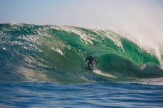 Doug Young tucked into an emerald tube during a tow session at a remote reefbreak near Dunedin, New Zealand. 