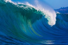 A wave breaks during a tow session at a remote reefbreak near Dunedin, New Zealand. 