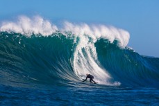 Doug Young drives off the bottom during a tow session at a remote reefbreak near Dunedin, New Zealand. 