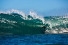 Doug Young gets barreled during a tow session at a remote reefbreak near Dunedin, New Zealand. 