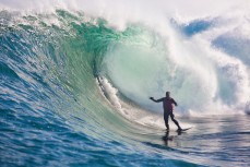 Kenny Kennedy lines up his very first barrel during a tow session at a remote reefbreak near Dunedin, New Zealand. 