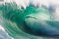 A wave breaks during a tow session at a remote reefbreak near Dunedin, New Zealand. 