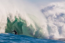 Sam Hawke rides deep in a barrel during a tow session at a remote reefbreak near Dunedin, New Zealand. 