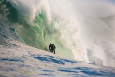 Doug Young all smiles deep in a cavern during a tow session at a remote reefbreak near Dunedin, New Zealand. 