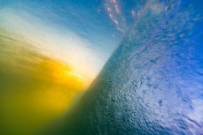 Sunset from beneath the waves at St Kilda Beach, Dunedin, New Zealand. 