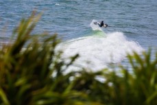 A surfer airs on a wave at Manu Bay, Raglan, New Zealand. 