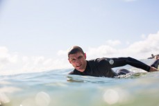 Kent Inglis paddles over a wave in fun playful conditions at the points, Raglan, New Zealand. 