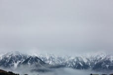 Mountains emerge from the clouds at Kaikoura, New Zealand. 