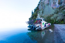 Chris Jolly Outdoors shuttle collects riders in Waihora Bay on a day ride of the Waihaha to Waihora section of the Great Lake Trail, Taupo, New Zealand.