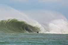 Dan "Delta" Smith rides a giant wave in the Southern Catlins, Southland, New Zealand. 