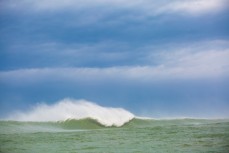 A giant wave breaks during a storm swell in the Southern Catlins, Southland, New Zealand. 