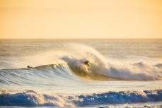 A surfer rips a wave apart at dusk at St Kilda Beach, Dunedin, New Zealand. 