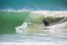 Lloyd McGinty lines up a barrel during a surf at a remote beach on Otago Peninsula, Dunedin, New Zealand. 