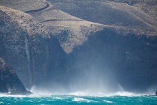 Storm surf crashes into cliffs near Allans Beach, Otago Peninsula, Dunedin, New Zealand. 