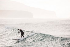 A surfer drives down a wave at St Clair Point, Dunedin, New Zealand. 