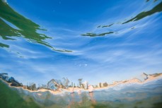 Dee Why Beach through a wave on the Northern beaches of Sydney, NSW, Australia. 