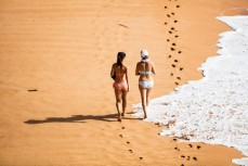 A couple of friends walk the beach at Avalon on the Northern Beaches of Sydney, NSW, Australia. 