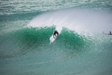 Tom Bracegirdle takes off on a wave at a remote beachbreak in the Catlins, New Zealand. 