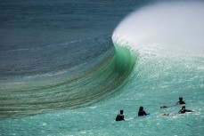 Surfers watch a peak break into the offshore wind at a remote beachbreak in the Catlins, New Zealand. 