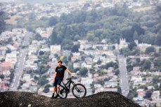 Bike Otago owner and founder of Black Seal Imports Kashi Leuchs in his backyard of Signal Hill above the city of Dunedin, New Zealand. 