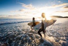 Surfers Zen Wallis and Christina Funck enjoy calm clean conditions at Aramoana, Dunedin, New Zealand. 