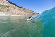 Surfer Christine Funck enjoys calm clean conditions at Aramoana, Dunedin, New Zealand. 