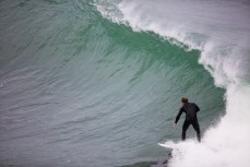 A surfer negotiates the kelp on the North Coast, Dunedin, New Zealand. 