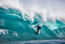 Doug Young rides deep in a barrel at a remote reefbreak near Dunedin, Otago, New Zealand. 