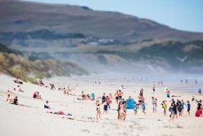 Crowds flock to St Kilda Beach on a 30°C summer day in Dunedin, New Zealand. 