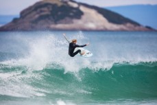 JC Susan takes to the air in fun waves at Blackhead Beach, Dunedin, New Zealand. 