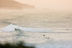 A surfer rides a fun wave at St Clair Beach, Dunedin, New Zealand. 