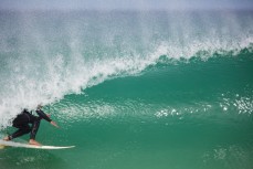 A surfer gets barreled in fun waves at Blackhead Beach, Dunedin, New Zealand. 