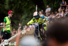 German rider Erik Irmisch drops through the crowd during the Crankworx World Tour downhill event held at Skyline Rotorua, Rotorua, New Zealand, March 9-13, 2016.