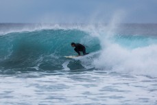 A surfer makes the most of fun waves at Back Beach, New Plymouth, Taranaki, New Zealand. 