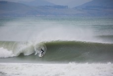Charlie Cox sets up for a solid swell at Aramoana, Dunedin, New Zealand. 
