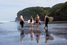 Mike Piercey, Talia Rose, Sofia Levi and Rose Halfpenny head out for a surf during the Canon Collective Beach Culture Workshop at the beautiful Bethells Beach, Auckland, New Zealand. 