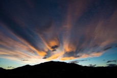 Golden clouds like molten rocks over Lake Hawea, Hawea, New Zealand. 